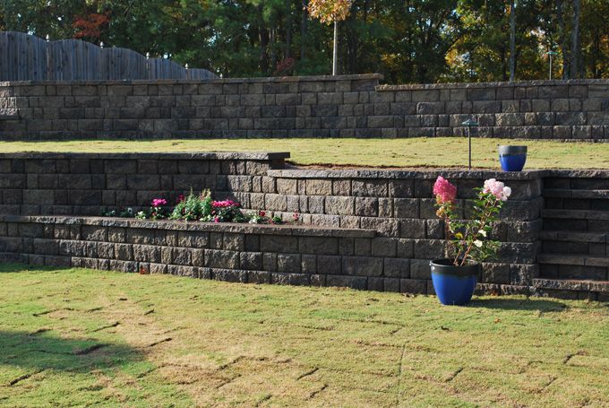 Appalachian blend retaining walls with flower beds supporting a downhill lawn slide 3-4
