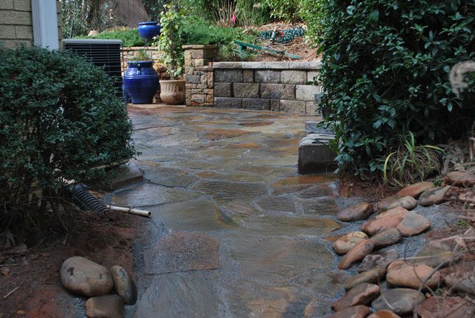 flagstone walkway with hardscapes on borders to control erosion and provide an escape for rain water