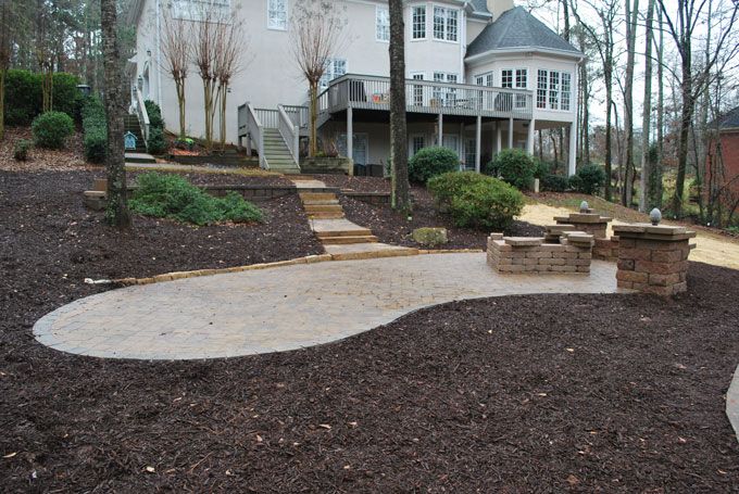 columns and bench wall near fire pit on a flagstone patio