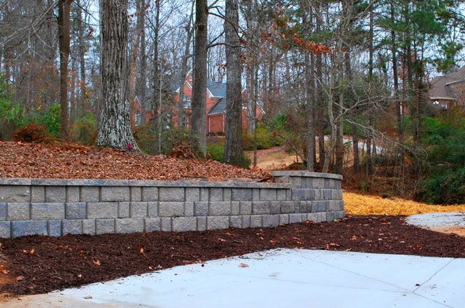 retaining wall supporting an area with autumn trees