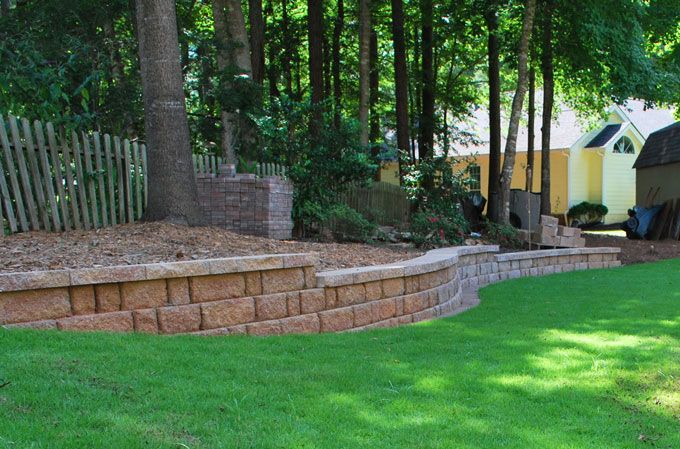 retaining stone wall along a downhill lawn