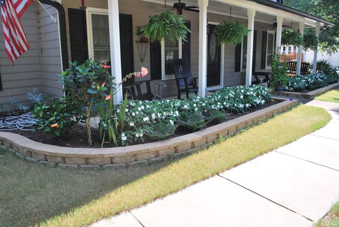 a nice looking border wall with plant bed at a front porch