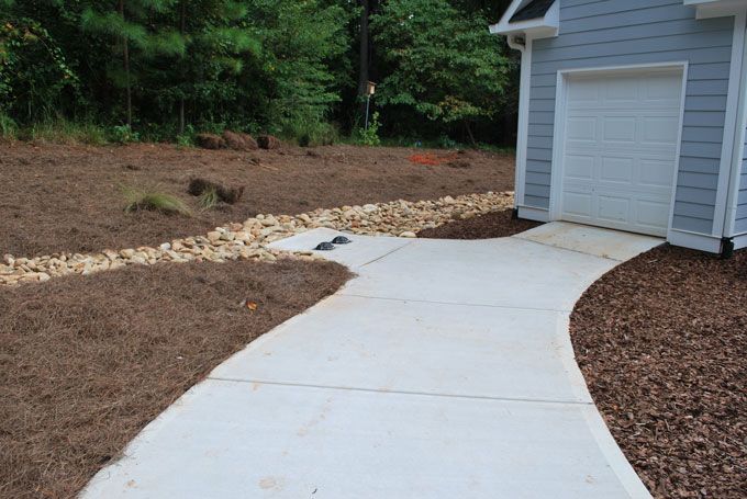 Two drain boxes in a concrete funnel & dry creek bed for the over flow