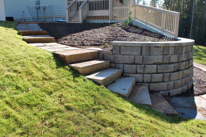 flower bed separated from the lawn with a garden path of stone