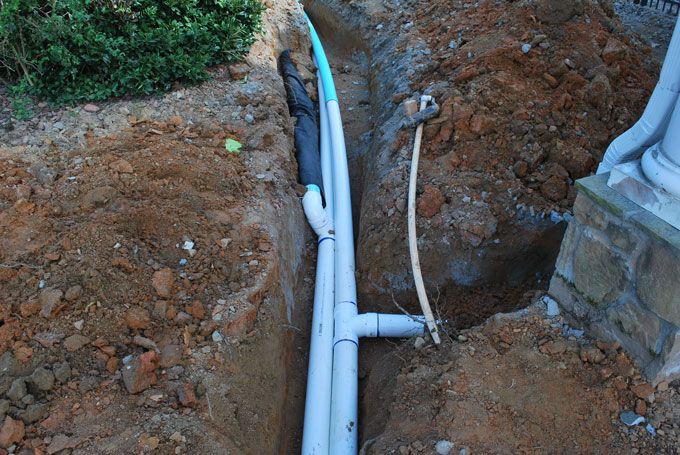 combining gravel pit french drains and downspout drains into one pipe will work if gravel pit is higher than downspout pipe