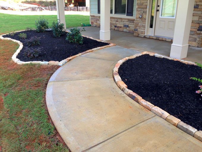 planters with rock edging blends matching stone house details