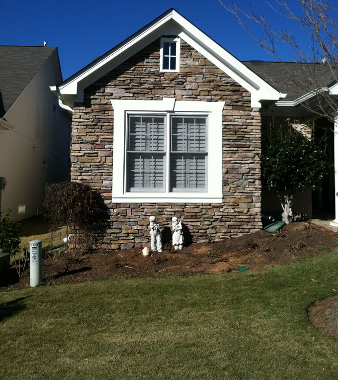 mulched part of a front yard before adding stack stone walls