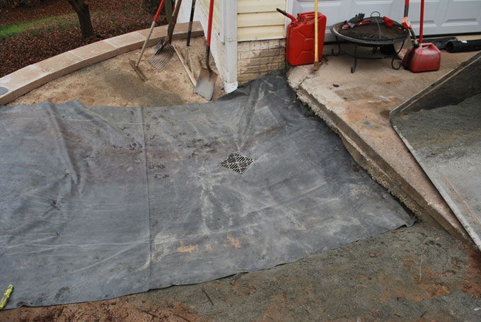 catch basin installation above retaining wall