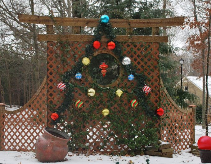a garden pergola with a season decoration in a shape of Christmas tree