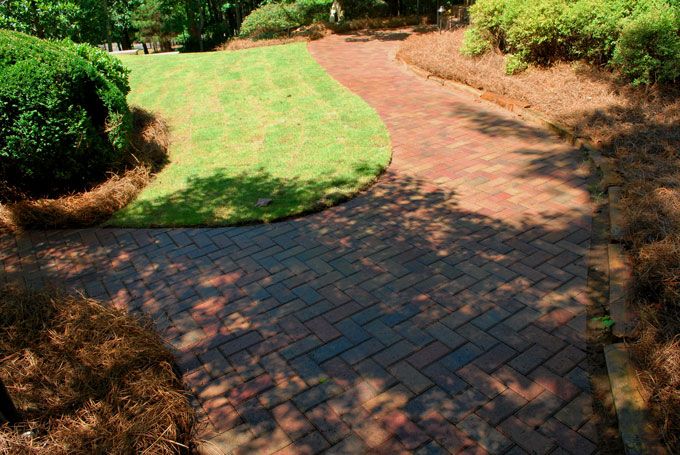 colorful curvy stone paver walkway in the front yard