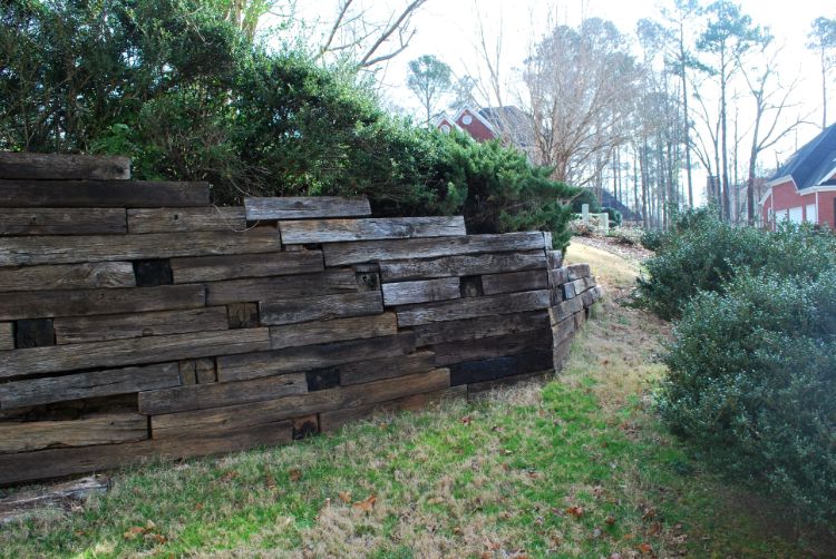 failing railroad timber wall before new retaining wall installation