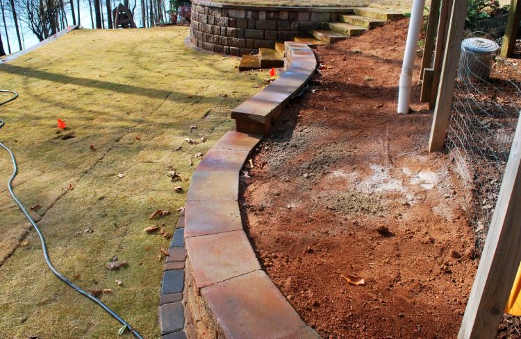 installation of retaining wall with flowing curves
