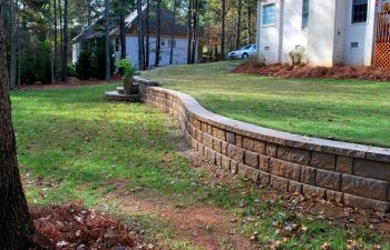 Leveled yard with a retaining wall.