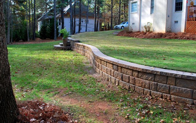 Leveled yard with a retaining wall.