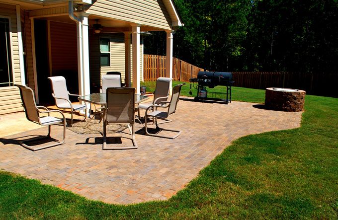 modified paver patio with a fire pit