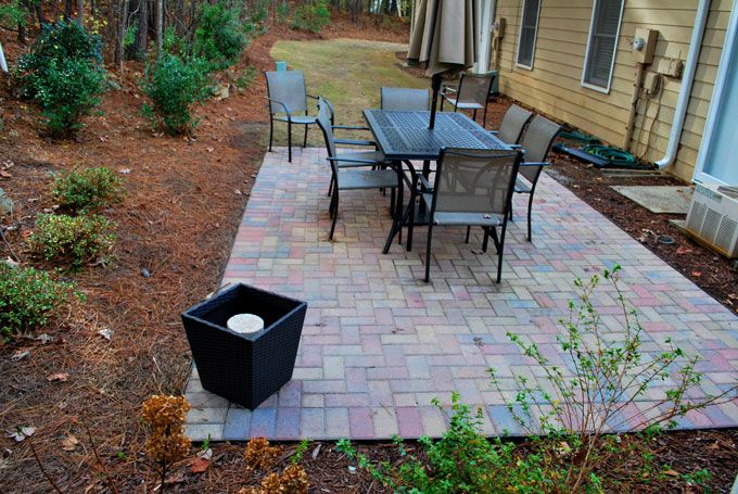 stone paver patio with a table and chairs