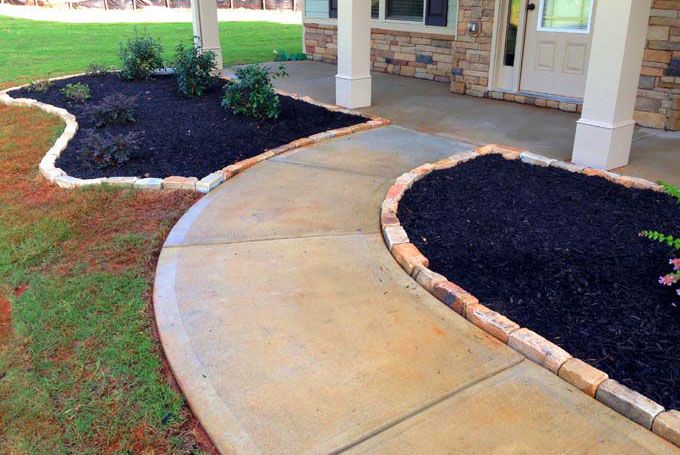 rock brick edging separating mulch from a walkway and lawn