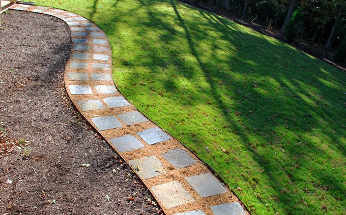 curvy garden walkway made of step stones and pea gravel