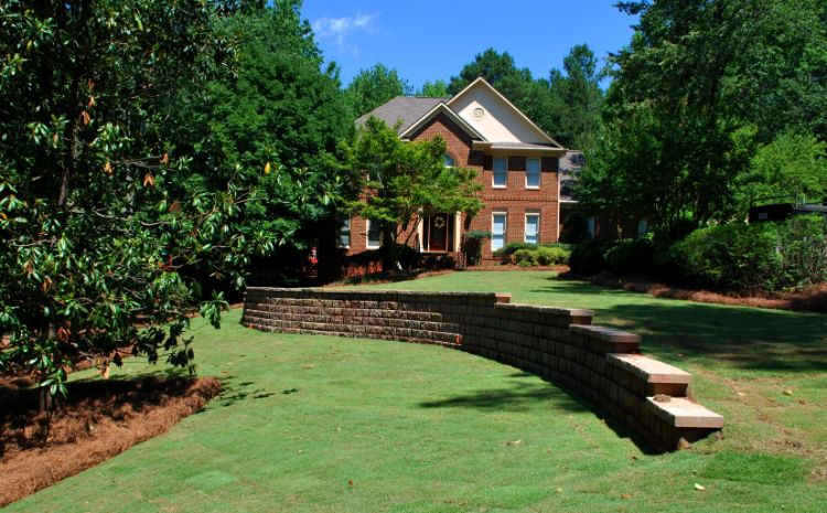 stepped wall installed to support large downhill lawn