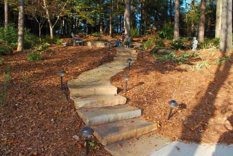 flowing path leading to hillside fire pit patio