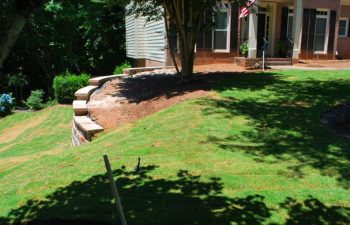 top of 99 inch retained wall supporting a downhill lawn with replaced sod