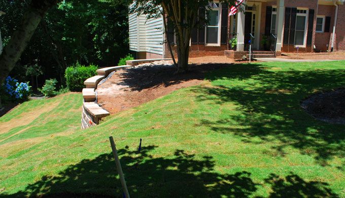 top of 99 inch retained wall supporting a downhill lawn with replaced sod