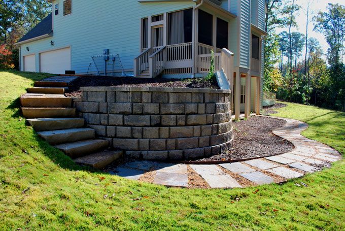 retaining wall with steps leading to a backyard pathway