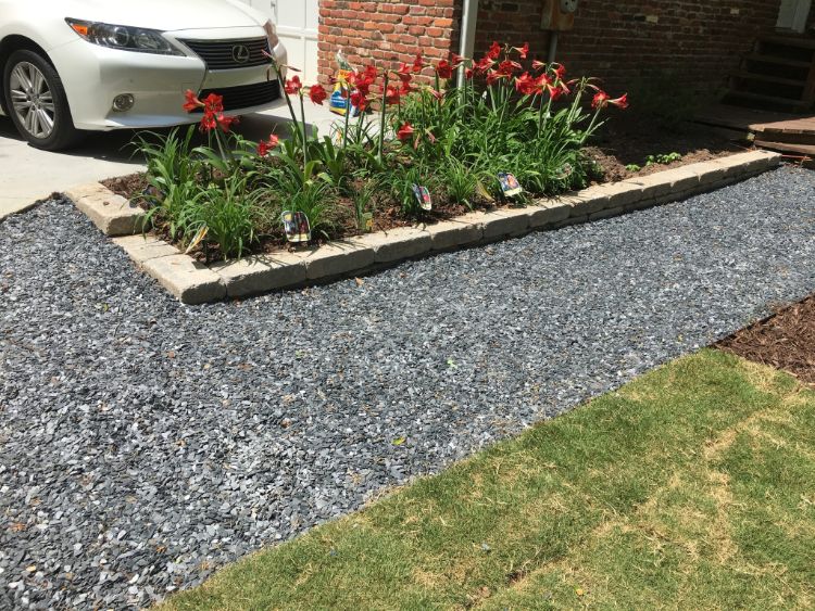 loose slate chips and rectangular bench blocks create a unique garden walk path